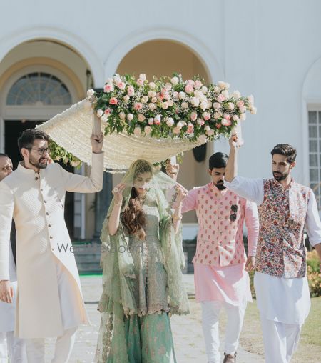 Photo of white bridal entry chadar with floral decoration