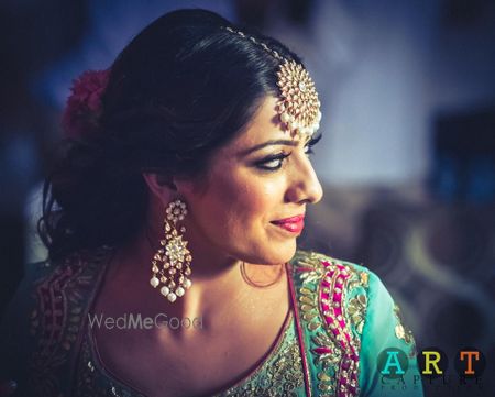 Photo of Bride in Turquoise Blouse and Polki Earrings