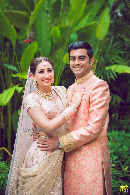 Photo of Matching bride and groom outfits in pastel shades