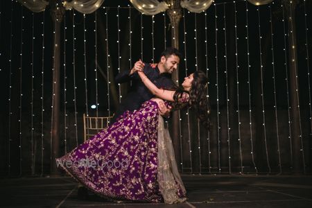 Photo of Candid shot of a dancing couple from their Sangeet.