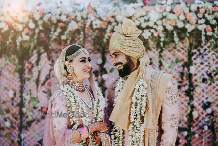 Photo of A bride and groom in coordinated outfits on their wedding day