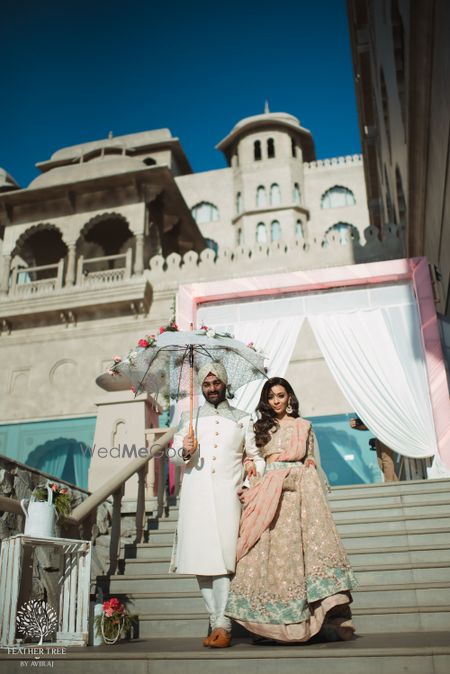 Photo of Engagement entry idea with couple entering under floral umbrella