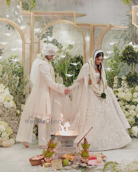 Photo of Alanna and Ivor in white custom Manish Malhotra outfits on their wedding day