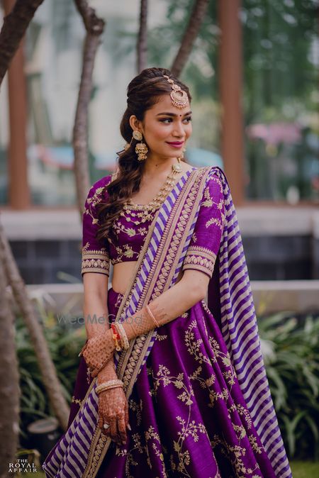 Photo of A bride in purple sabyasachi lehenga for her mehendi