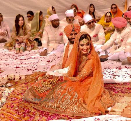 Photo of Sikh Couple Shot - Orange Sabyasachi Lehenga