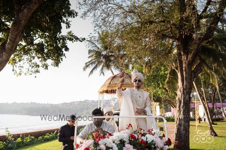 Photo of Groom entering with baraat in car with floral decoration