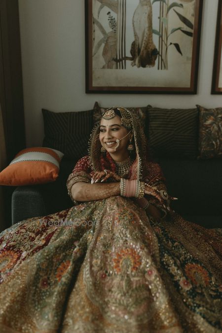 Photo of Timeless and classic bridal portrait with a light pink chooda and heavy lehenga