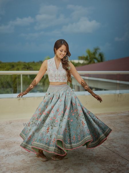 Photo of mehendi bridal look with bride twirling in short lehenga