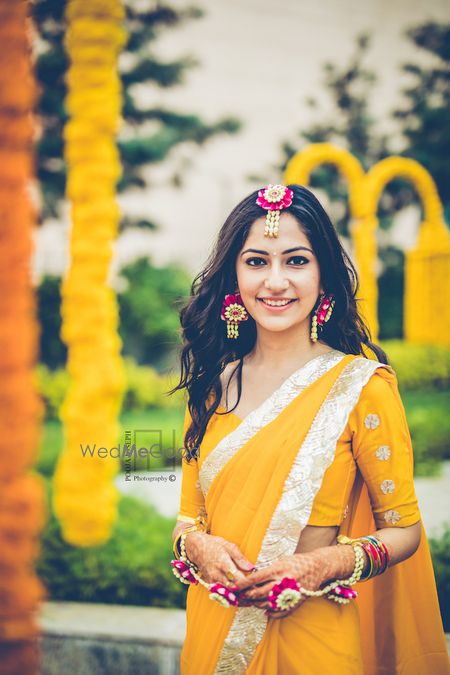 Photo of Bride wearing floral jewellery on haldi