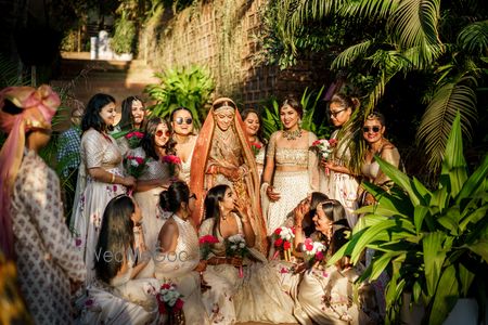 Photo of bride with her matching bridesmaids on her wedding day