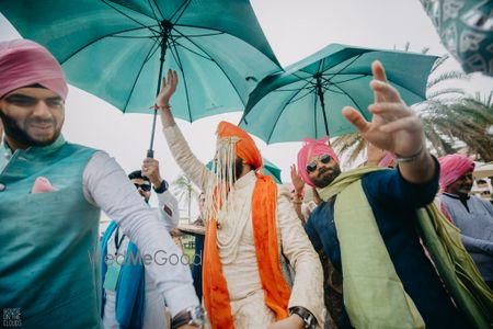 Photo of baraat shot with umbrellas