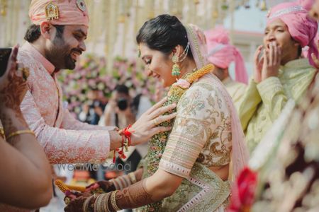 Photo of A candid couple portrait captured during jaimala ceremony