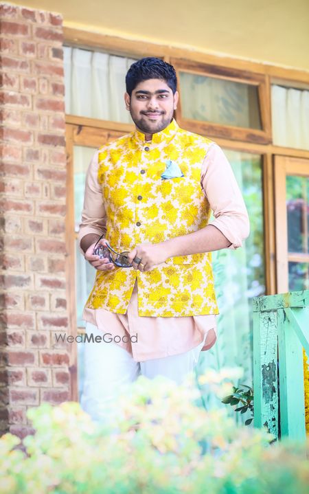 Photo of Yellow nehru jacket with kurta on mehendi