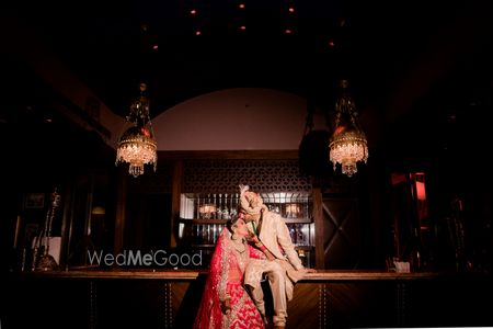 Photo of A cute couple portrait with the groom kissing bride's forehead