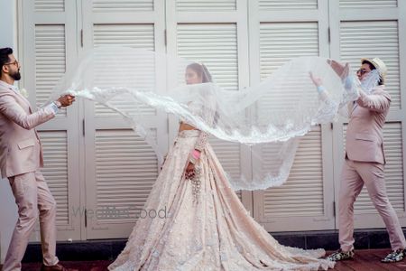 Photo of A perfect shot of the bride and her brothers