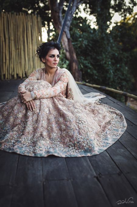 Photo of Bride in blush pink lace Sabyasachi lehenga