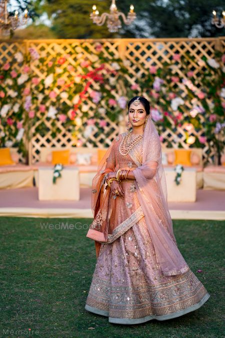 Photo of bride in offbeat light peach bridal lehenga by ritu kumar