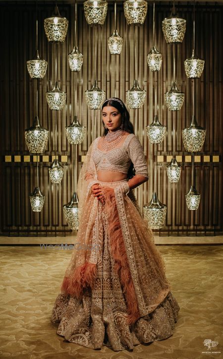 Photo of bride in a peach falguni and shane lehenga on her reception