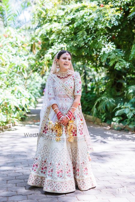 Photo of Bride wearing white lehenga on her wedding day