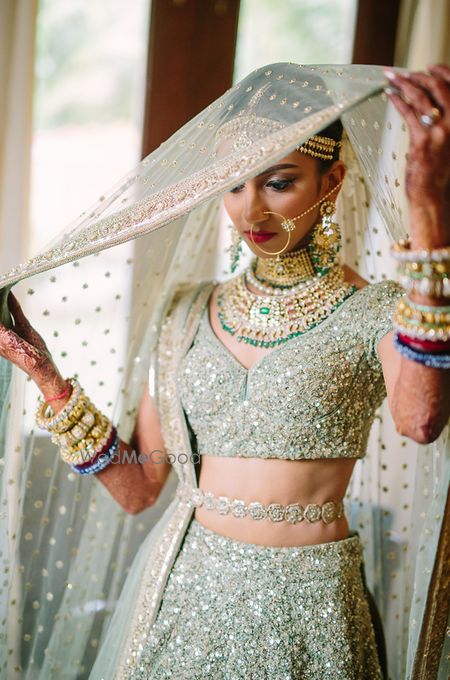 Photo of Shimmery bridal lehenga with waist belt