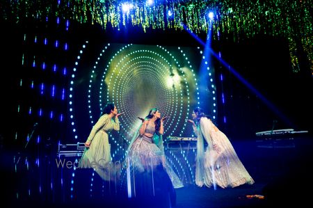 Photo of bride and bridesmaids dancing shot