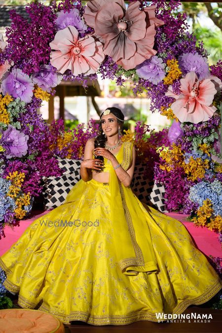 Photo of Brde in a bight and dreamy Sabyasachi lehenga for her Mehendi