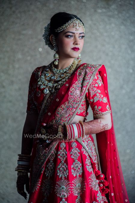 Photo of Bride in red with Abu Jani sandeep Khosla lehenga