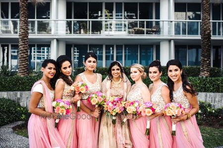 Photo of Bride with bridesmaids holding bouquets