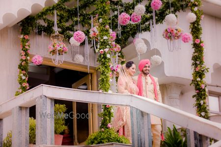 Photo of Pink and white floral balls with green ferns