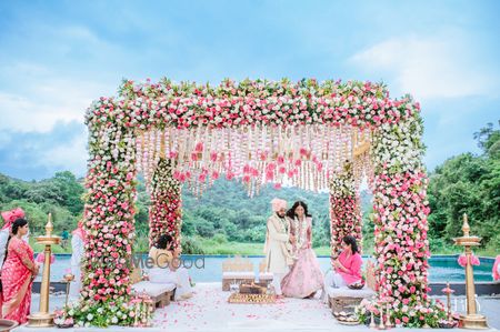 Photo of couple shot while taking pheras in mandap