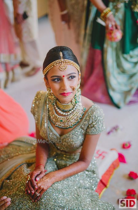 Photo of Bride earing polki jewellery and sparkly lehenga