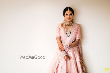 Photo of Bride in a light pink lehenga