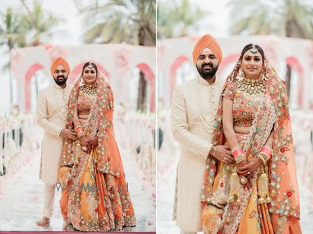 Photo of matching sikh bride and groom in orange outfits