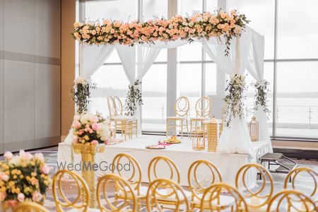 Photo of indoor white and gold theme minimal mandap