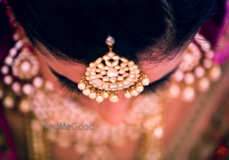 Photo of white and gold kundan maang tikka