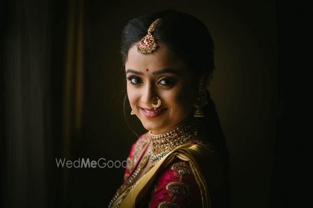 Photo of Happy bridal posing in beautiful gold jewellery.