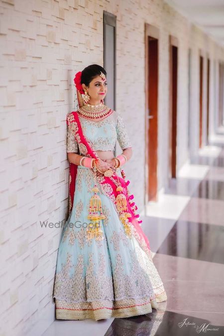 Photo of A bride in powder pink lehenga and baby pink chooda.