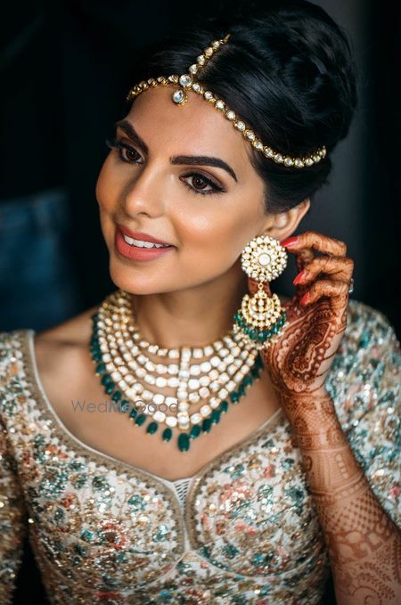 Photo of Polki bridal jewellery set with green beads and simple maangtikka