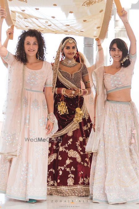 Photo of Unique bridal entry with bridesmaids holding phoolon ka chadar