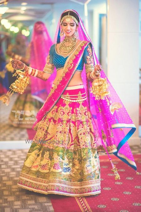 Photo of Kitsch hot pink bridal lehenga with cobalt blue blouse