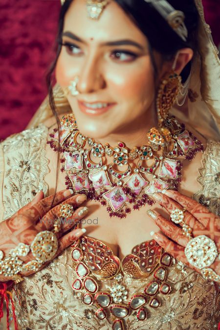 Photo of Bride wearing an enameled bridal choker with a rani haar.