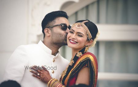 Photo of South Indian wedding with groom kissing bride