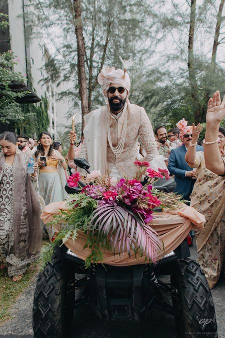 Photo of Super cool baraat entry with the groom entering the wedding on an ATV