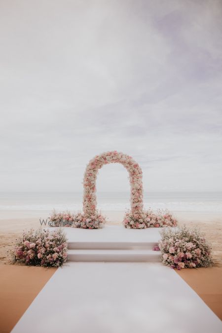 Photo of Stunning pastel themed floral decor archway for a day outdoor wedding