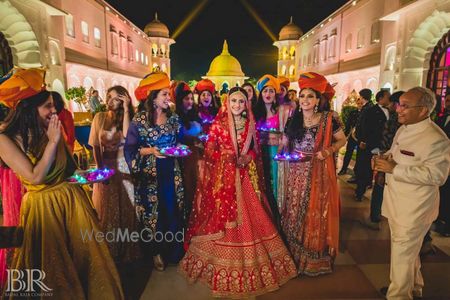 Photo of Bride entering with bridesmaids holding LED thalis