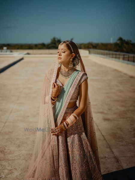 Photo of pastel bridal look with a babys breath bun