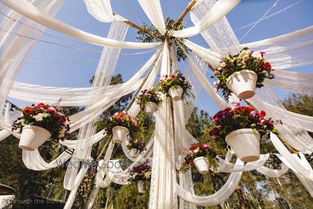 Photo of Hanging flower pots in decor with white drapes