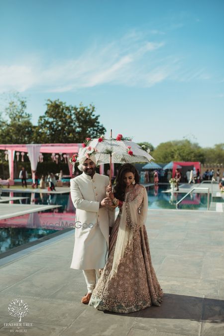 Photo of Bride and groom engagement entry idea under floral umbrella