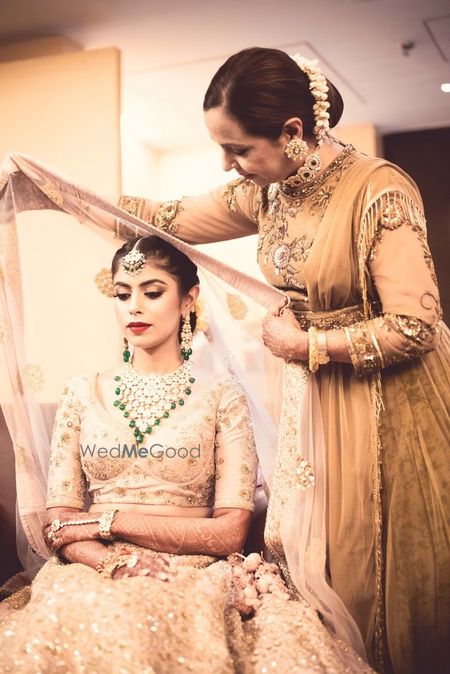 Photo of Pretty mom placing dupatta on bride for wedding