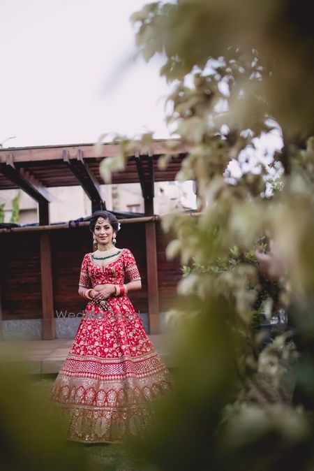 Photo of Bride in red embellished lehenga long shot